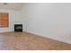 Bright living room with a cozy fireplace, window with blinds, and tile flooring at 516 Jaclyn Cir, Mcdonough, GA 30253