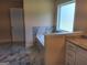 A primary bathroom featuring a soaking tub with marble surround and granite countertop vanity at 200 Parker Dr, Mcdonough, GA 30253