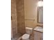 This bathroom includes a toilet, a vanity with granite countertop, and a tiled shower at 200 Parker Dr, Mcdonough, GA 30253