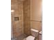 This bathroom includes a toilet, a vanity with granite countertop, and a tiled shower at 200 Parker Dr, Mcdonough, GA 30253