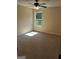 Bright bedroom featuring a ceiling fan, carpeted floor, and natural light from the window at 200 Parker Dr, Mcdonough, GA 30253