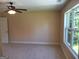 Bedroom with carpeting, a ceiling fan, a window, and a white door at 200 Parker Dr, Mcdonough, GA 30253