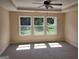 Bedroom features three large windows providing natural light and a ceiling fan for optimal comfort at 200 Parker Dr, Mcdonough, GA 30253