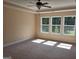 A bright bedroom features three windows and a ceiling fan with lights at 200 Parker Dr, Mcdonough, GA 30253