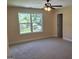 A bedroom features carpeting, a window, and a ceiling fan at 200 Parker Dr, Mcdonough, GA 30253