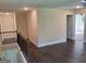 Spacious bonus room with wood floors, wooden railing, and an open doorway to another room at 200 Parker Dr, Mcdonough, GA 30253