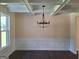 The dining room features modern floors, wainscoting detail, and a modern light fixture at 200 Parker Dr, Mcdonough, GA 30253