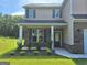 Charming two-story home features a covered porch and manicured landscaping, enhancing curb appeal and a welcoming entrance at 200 Parker Dr, Mcdonough, GA 30253