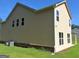Two-story home with beige siding, white trim, and a well-manicured lawn under a clear blue sky at 200 Parker Dr, Mcdonough, GA 30253