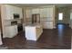 Open-concept kitchen features stainless steel appliances, granite countertops, and white cabinetry at 200 Parker Dr, Mcdonough, GA 30253