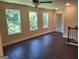 A cozy living area with wood floors, a staircase and 3 windows at 200 Parker Dr, Mcdonough, GA 30253