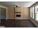 Inviting living room features a ceiling fan, modern fireplace, and an abundance of natural light at 200 Parker Dr, Mcdonough, GA 30253