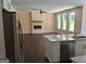 Open-concept space showing the modern kitchen island adjacent to the cozy fireplace in the living room at 200 Parker Dr, Mcdonough, GA 30253