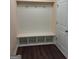 Mudroom features a bench with storage cubbies and hooks for coats and bags, next to a white door at 200 Parker Dr, Mcdonough, GA 30253