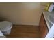 Small bathroom with toilet, sink, and wood flooring at 2590 Wellington Walk Pl, Lithonia, GA 30038