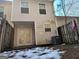 Rear view of the townhouse showing the back entrance and AC unit at 2590 Wellington Walk Pl, Lithonia, GA 30038