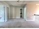 Upstairs hallway boasts neutral walls, carpet, and wrought iron handrail at 502 Hinton Farm Way, Dacula, GA 30019