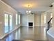 Bright living room with fireplace, hardwood floors, neutral walls and modern chandelier at 502 Hinton Farm Way, Dacula, GA 30019