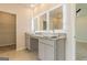 Bathroom vanity with dual sinks, granite countertops, framed mirrors, and stylish vanity lights offers contemporary luxury at 359 Orwell Dr # 53, Social Circle, GA 30025