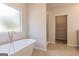 Bathroom showcasing a soaking tub, walk-in shower, and walk-in closet at 359 Orwell Dr # 53, Social Circle, GA 30025