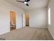 Bedroom with ensuite bathroom, walk-in closet, neutral carpet and ceiling fan at 359 Orwell Dr # 53, Social Circle, GA 30025