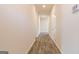 Bright hallway featuring hardwood floors, white walls, and recessed lighting creating a clean, modern aesthetic at 359 Orwell Dr # 53, Social Circle, GA 30025