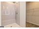 Modern shower with tile surround and built in seat, adjacent to walk-in closet at 359 Orwell Dr # 53, Social Circle, GA 30025