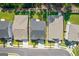 Birds eye view of house with driveway and dark shingled roof, surrounded by mature trees and green grass at 704 Chipping Sparrow St, Canton, GA 30115