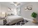 Cozy bedroom featuring a ceiling fan, neutral walls, and framed art that creates a relaxing retreat at 704 Chipping Sparrow St, Canton, GA 30115