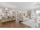 Bright and open living room with stylish furniture, chandeliers, and hardwood flooring at 704 Chipping Sparrow St, Canton, GA 30115
