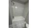 A close up of the shower and tub with a white tiled surround at 1457 Richland Sw Rd, Atlanta, GA 30310