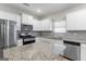 Modern kitchen with stainless steel appliances, granite countertops, and white cabinetry at 8069 Louis Dr, Locust Grove, GA 30248