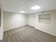 Unfinished basement with carpet, built-in shelving, and neutral walls perfect for storage or converting to livable space at 200 Eagle Glen Ct, Woodstock, GA 30189