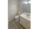 Well-lit bathroom featuring decorative tile flooring, a toilet, vanity, and updated light fixture at 200 Eagle Glen Ct, Woodstock, GA 30189