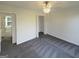 Bright bedroom with neutral walls, gray carpet, a ceiling fan, and an open closet for ample storage at 200 Eagle Glen Ct, Woodstock, GA 30189