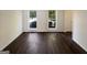Well-lit bedroom showcasing hardwood floors, two windows, and a closet that offers storage solutions at 200 Eagle Glen Ct, Woodstock, GA 30189