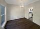 Dining room with hardwood floors, updated light fixture and an open doorway leading into the kitchen at 200 Eagle Glen Ct, Woodstock, GA 30189