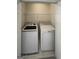 Laundry room with a washer, dryer, and wire shelving for convenient laundry storage solutions at 200 Eagle Glen Ct, Woodstock, GA 30189