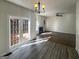 Living room with hardwood floors, fireplace, and french doors leading to the backyard deck at 200 Eagle Glen Ct, Woodstock, GA 30189