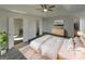 Primary bedroom featuring a tray ceiling, ceiling fan, ensuite bath, and walk-in closet at 200 Eagle Glen Ct, Woodstock, GA 30189