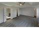 Spacious primary bedroom featuring a tray ceiling, ceiling fan, ensuite bath, and walk-in closet at 200 Eagle Glen Ct, Woodstock, GA 30189