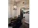 Dining area with modern chandelier and kitchen view at 9388 Crest Knoll Ct, Jonesboro, GA 30238