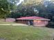 A single-story brick home features a metal roof and an attached two-car garage at 10108 Lakeview Sw Dr, Covington, GA 30014