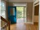 Bright entryway with hardwood floors and a teal front door leading to a deck at 1009 Longley Nw Ave, Atlanta, GA 30318