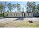 Ranch style home with a spacious yard and mature trees at 1092 W Adrian Sw Cir, Conyers, GA 30094
