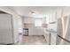 Clean kitchen with white cabinets, stainless steel appliances, and laminate floors at 1092 W Adrian Sw Cir, Conyers, GA 30094