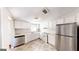 Modern kitchen features stainless steel appliances and light wood-look flooring at 1092 W Adrian Sw Cir, Conyers, GA 30094