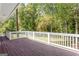 Large wooden back deck with white railing overlooks the backyard at 504 Milligan Dr, Stone Mountain, GA 30083