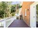 Backyard deck of a brick house overlooking lawn, shrubs and mature trees at 504 Milligan Dr, Stone Mountain, GA 30083