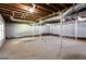 Unfinished basement with concrete floors, white brick walls and exposed ceiling at 504 Milligan Dr, Stone Mountain, GA 30083